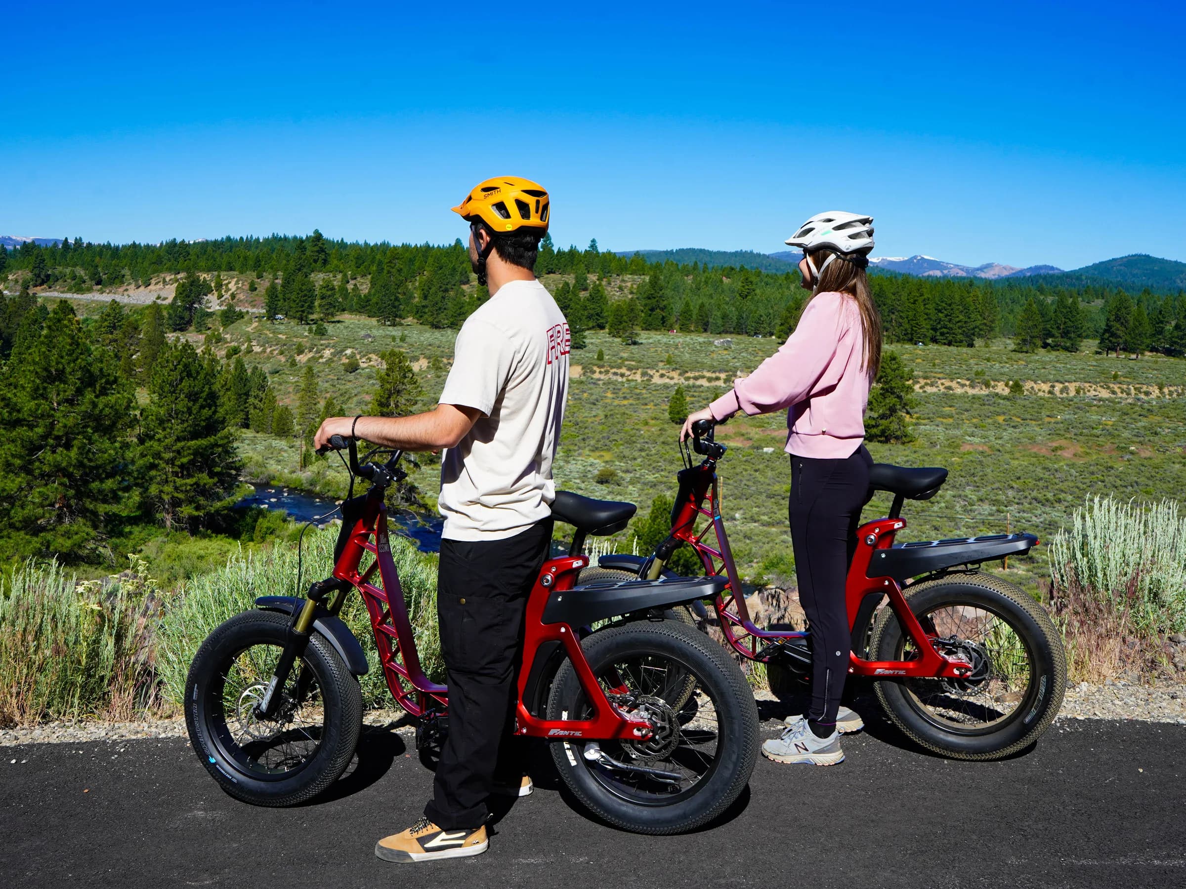 Two riders exploring a Tahoe bike path on red Fantic Issimo e-bikes