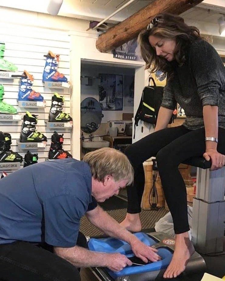 Buck fitting a customer's foot on the casting stand in the Olympic Valley shop